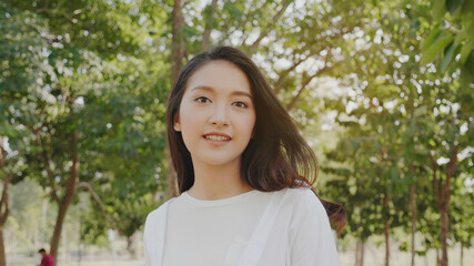 Authentic close up Happy pretty asian woman. Enjoy the nature in garden for summer. End of...