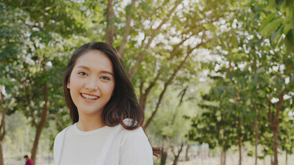 Fototapeta premium Authentic close up Happy pretty asian woman. Enjoy the nature in garden for summer. End of quarantine and return to Travel around the world