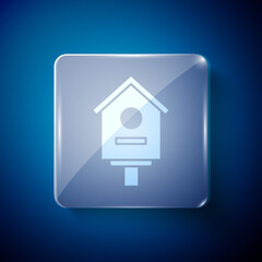 White Bird house icon isolated on blue background. Nesting box birdhouse, homemade building for birds. Square glass panels. Vector Illustration.