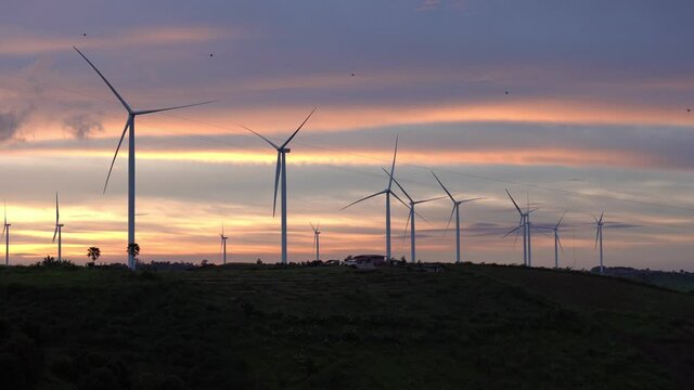 Time-Lapse of The wind turbines at sunset. Wind turbine generator wind energy plant power turbine renewable electric energy production .high definition footage. 