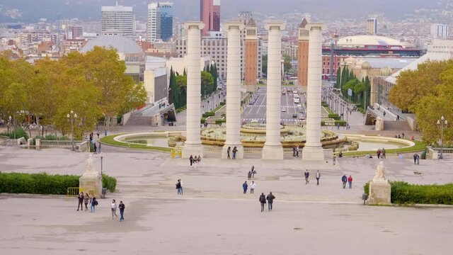 A long view of The Venetian Towers and Magic Fountains on Avinguda de la Reina Maria Cristina at its junction with Pla&ccedil;a d'Espanya in Barcelona, Catalonia, Spain.