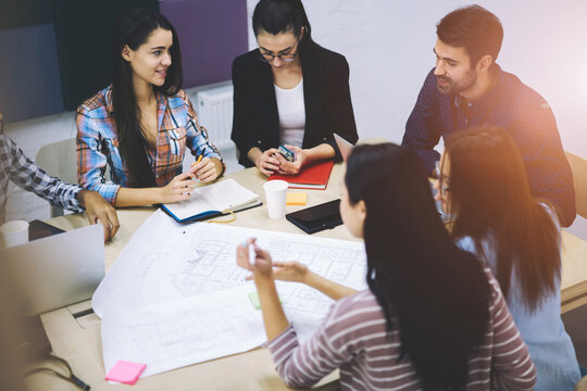 Diversity group of talented engineers actively discussing business startup project ideas and surfing information using modern technology,hipster guys talking in friendly atmosphere during work break - Powered by Adobe