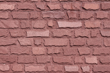Red stone wall background. Decorative stone texture