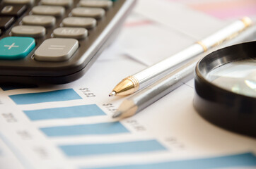 Magnifier calculator lies on a color chart. financial responsibility