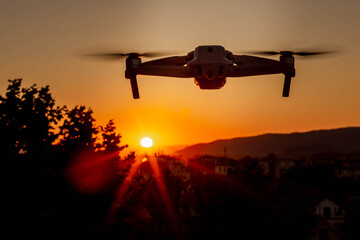 Photo of a drone flying in the air in the sunset light