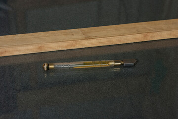 Oil glass cutter close-up on glass surface