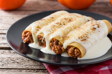 Delicious meat cannelloni pasta on wooden table