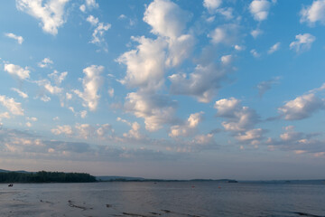 White clouds over the river in the morning blue sky