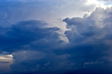 Naklejka na ściany i meble A stormy landscape with blue Cumulus clouds on the horizon.
