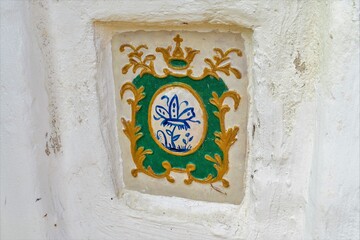 Russia, Uglich, July 2020. Antique tile with religious symbols that adorns the monastery wall.