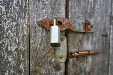 Old rusty lock on the wooden door