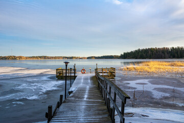 Naklejka premium Wooden pier on the shore and view to The Gulf of Finland, Majvik, Kirkkonummi, Finland