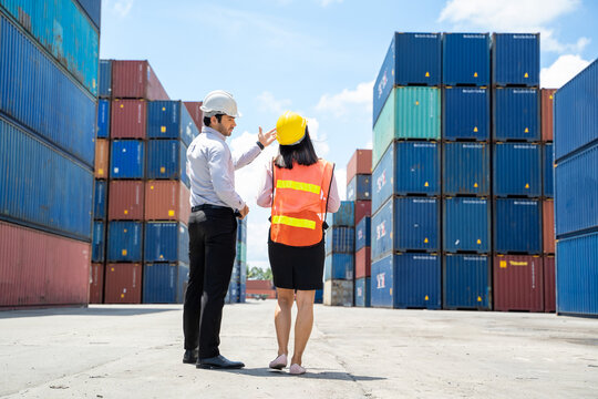 Manager and contenner worker working in the construction container yard,Industrial container yard for import and export for business concept.