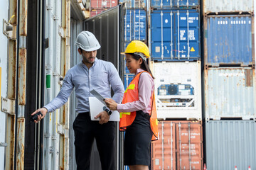 Businessman and businesswoman working together at container cargo,Warehouse shipping transportation concept for logistic.