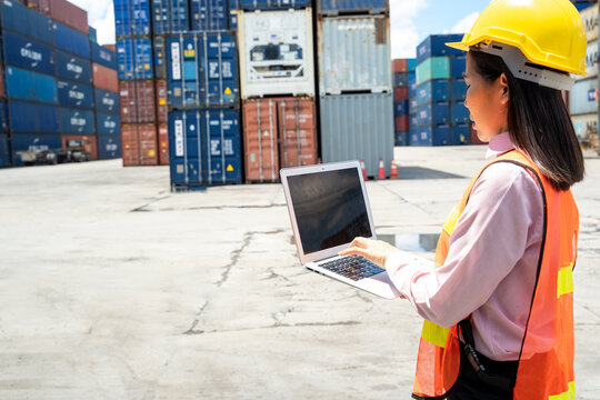 Contenner woman worker with laptop checking position loading containers box,Large container shipping at shipping yard main transportation of cargo container shipping