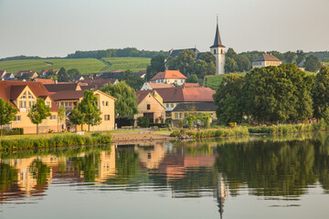 Fototapeta na wymiar Church and homes along the Main-Danube Canal, Schweinfurt, Germany