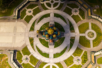 dark color temple with golden domes with geometric park from drone height