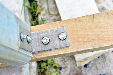 Fasteners of a wooden structure with the help of an iron corner and self-tapping screws