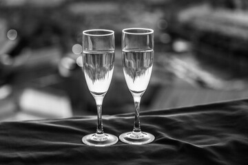 Two glasses of champagne on the background of city roofs at sunset