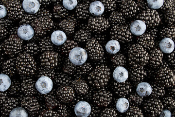 Fruit background. Closeup on blackberries and blueberries.