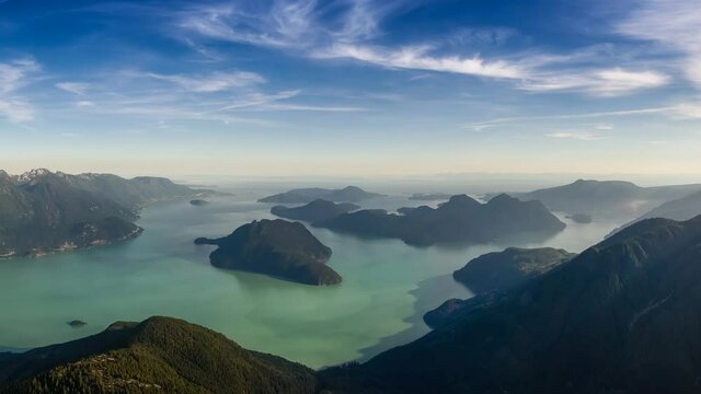 Cinemagraph Continuous Loop Animation. Aerial View of Howe Sound and Beautiful Canadian Mountain Landscape during sunny and cloudy day. Taken near Vancouver, British Columbia, Canada.