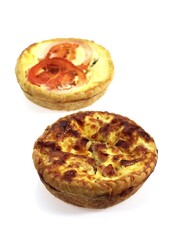 Leek Quiche and Tuna Quiche with Tomatoe against White Background