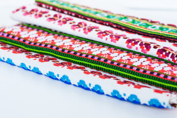 A stack of woven linen towels with embroidery, traditional handmade in Ukraine