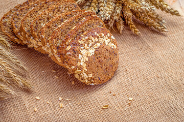 Freshly baked bread. Fresh loaf of rustic traditional bread with wheat grain ear or spike plant on...