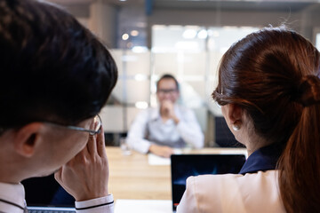 Image of business men and women interviewing one employee to work in a team