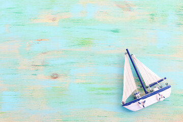 wooden vintage boat over blue background
