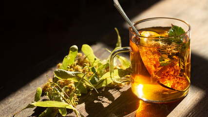 Hot lime blossom drink and linden flowering branch
