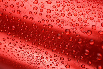 Red aluminum can with water drops or dew.