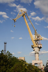 Fototapeta na wymiar abandoned shipyard crane in soviet town