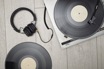 Vinyl player with long play or LP records and headphones.