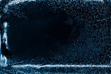 Pure transparent ice block on black background.