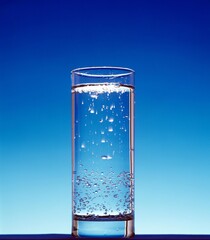Glass of Sparkling Water against Blue Background