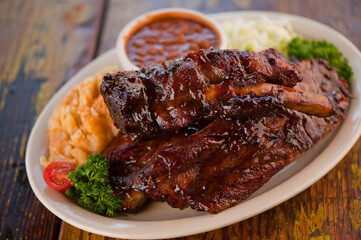 Pork ribs, barbecue style. Classic Traditional Texas Smokehouse favorite menu item: Baby Back pork ribs. Slow cooked in seasoned smoker over mesquite wood chips covered in homemade bbq sauce. 