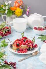 Sponge cake with summer berries, side view