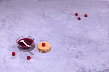 raspberry jam in a glass plate and cookies