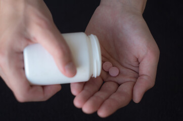 Female hand holding medicine and packaging close up