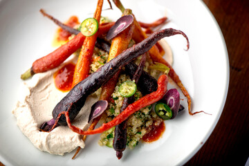 Carrots. Roasted caramelized carrots. Bunch of farm fresh farm to market rainbow carrots. Organic root vegetable, ingredients for menu items at traditional American or french bistro restaurants. 