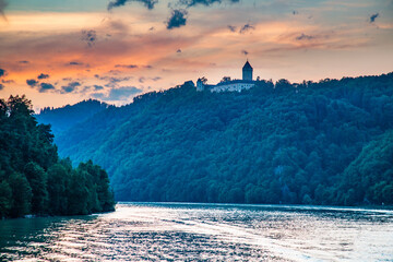 the danube river at dusk with a castle on the hill above, near Sausenstein, Austria