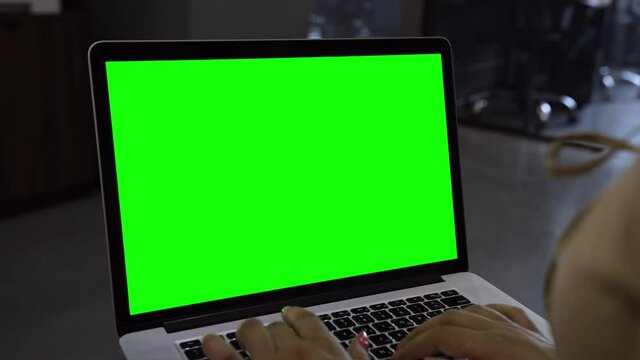 Laptop template with white transparent screen, computer blank display isolated. Metal device. Fingers press keys of the keyboard. Green