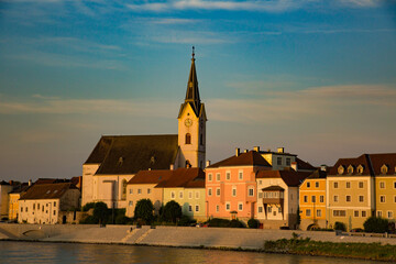 A church with clock tower along the Danube river near Sausenstein, Austria,