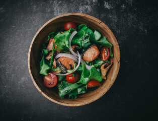 top view,Roasted salmon fillet with fresh vegetable salad on wooden bowl , grilled red fish fillet...