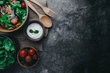 Food background and copy space, view,Roasted salmon fillet with fresh vegetable salad on wooden bowl , grilled salmon and tomatoes, cucumbers, olives and red onion,clean and healthy food concept.