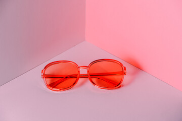 Stylish pink sunglasses on modern minimal background, front view. Nobody. Product photograph