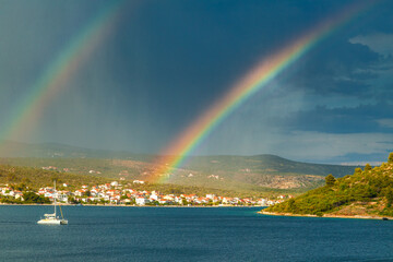 Rainbow over the sea bay near The Rogoznica village, a popular tourist destination on the Dalmatian coast of Adriatic sea in Croatia, Europe.