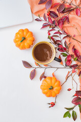 Flat lay composition with colorful autumn leaves, laptop,scarf and a cup of coffee on a white background