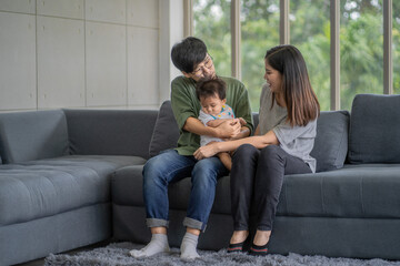 Diversity Lesbian sitting with cute toddler girl in between. Happiness and family bonding in LGBTQ family, LGBT lifestyle.